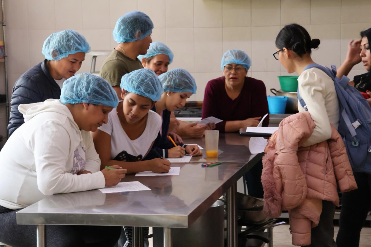 Grupo de mujeres participa en un taller de formación en la cocina del centro Scalabrini